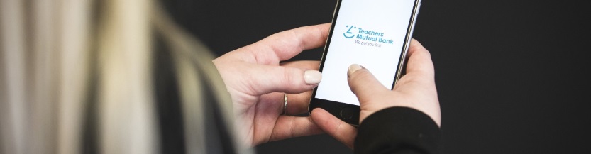 person using TMB mobile banking app, developed by Cuscal