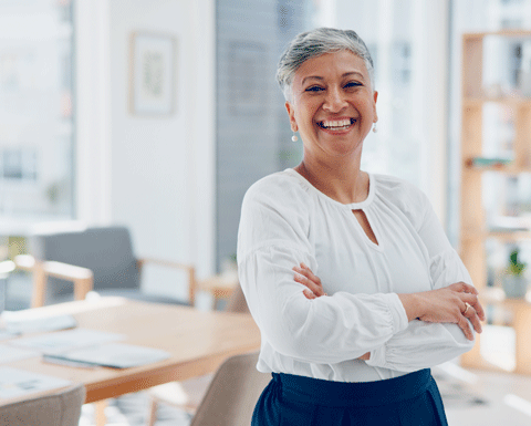 Lady standing with her arms folded.